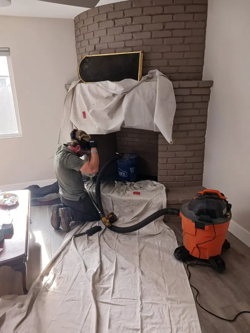 Sweeping and vacuuming soot from a brick firebox