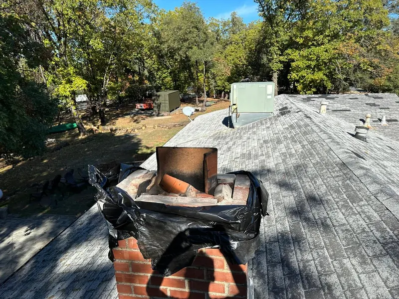 Stainless chimney cap installed over the flue